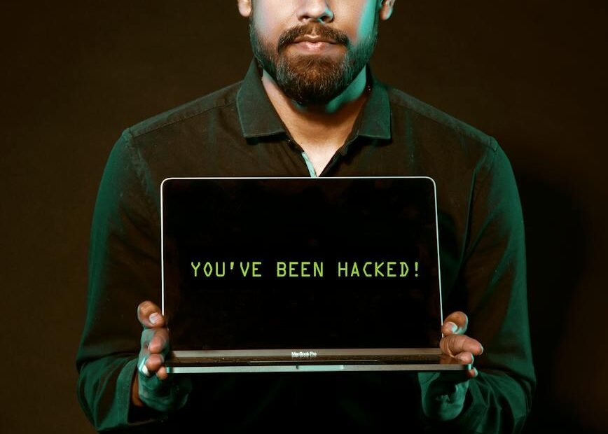 man holding laptop computer with both hands